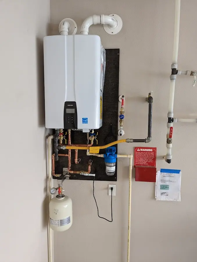Professional plumber installing copper piping in a Westwood home